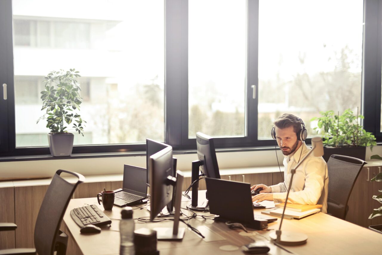 Man on computer with headphones