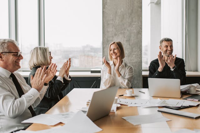 Team clapping in meeting
